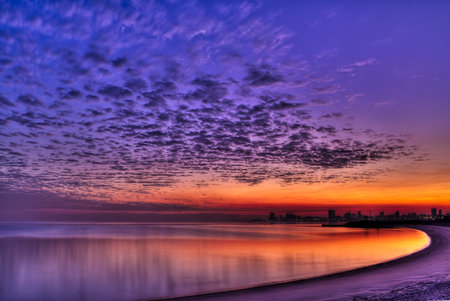 Cityscape for Kuwait City from the beach at sunrise, in winter 