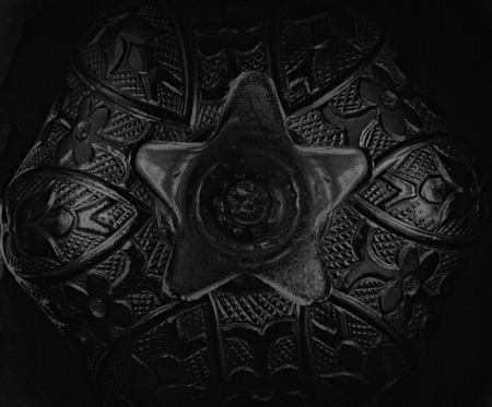 Macro shot for an abstract made from silverware with intricate design and dramatic lighting on the sides. Image converted to B&W.の写真素材