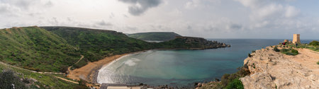 Panoramic view of Riviera beach with Ghajn Tuffieha tower in Malta