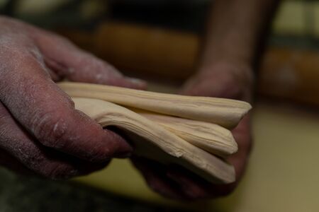 dough before being turned into large croissants viewed up close in a bakeryの写真素材