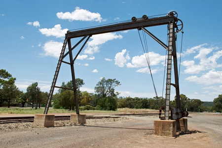 an old crane at the railway crossingの写真素材