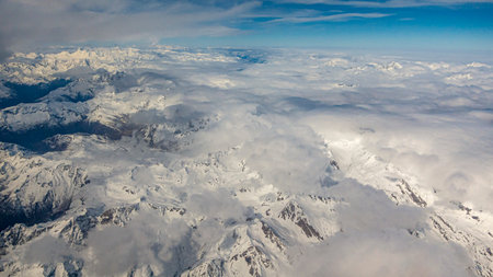 Aerial picture of the alps with deep hanging clouds