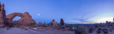 Panoramic picture of impressive sandstone formations in Arches National Park at nightの写真素材
