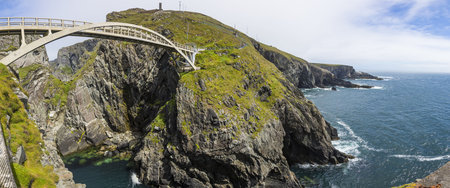 Panoramic picture of pedastrian bridge to Mizen Head lighthouse in south Ireland during daytime