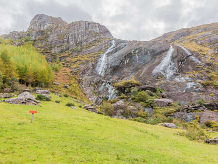 Typical Irish landscape with green meadows and rough mountainsの写真素材