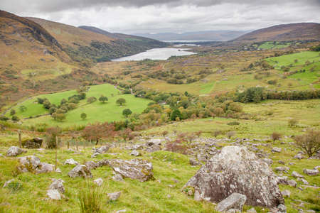 Typical Irish landscape with green meadows and rough mountainsの写真素材