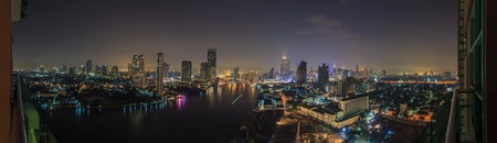 Panoramic aerial night picture of the Bangkok skyline and Chao Phraya riverの写真素材