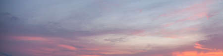 Dramatic colorful sky with afterglow and illuminated clouds at evening timeの写真素材