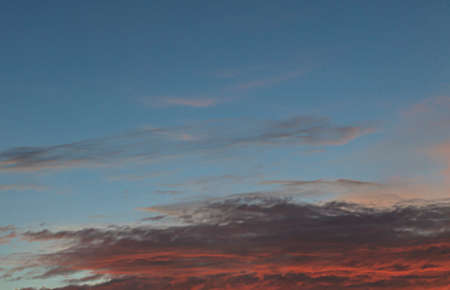 Dramatic colorful sky with afterglow and illuminated clouds at evening timeの写真素材