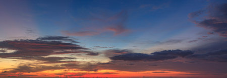 Dramatic colorful sky with afterglow and illuminated clouds at evening time