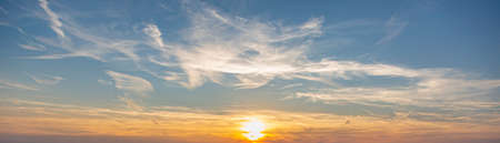 Dramatic colorful sky with afterglow and illuminated clouds at evening timeの写真素材