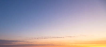 Dramatic colorful sky with afterglow and illuminated clouds at evening timeの写真素材