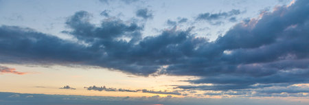 Dramatic colorful sky with afterglow and illuminated clouds at evening time