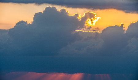 Dramatic colorful sky with afterglow and illuminated clouds at evening time