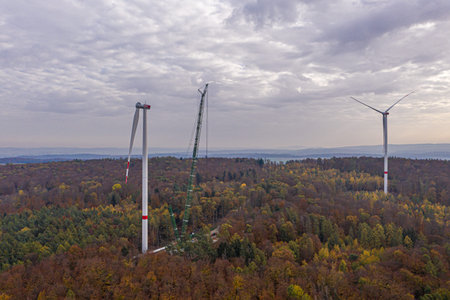 Drone image of a wind turbine under construction in a forest area in Germany in autumn