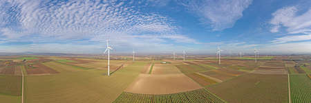 Panoramic aerial photo of a wind farm in Germany during the day with blue sky and light cloudsの写真素材