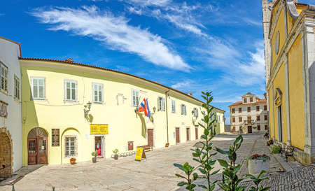 Panorama over the central square of Motovun with St. Stephen's church and city gate during the day in summerの写真素材