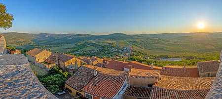 Panoramic view from the city wall of Motovun over the surrounding countryside during the day in summerの写真素材