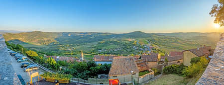 Panoramic view from the city wall of Motovun over the surrounding countryside during the day in summerの写真素材
