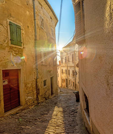 Picture of the romantic cobblestone access road to the historic center of the Croatian town of Motovun in summerの写真素材