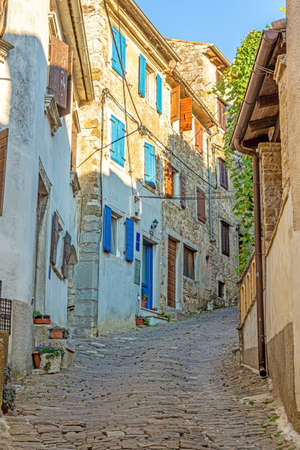 Picture of the romantic cobblestone access road to the historic center of the Croatian town of Motovun in summerの写真素材
