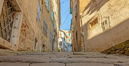 Picture of the romantic cobblestone access road to the historic center of the Croatian town of Motovun in summerの写真素材