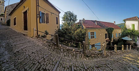 Picture of the romantic cobblestone access road to the historic center of the Croatian town of Motovun in summerの写真素材