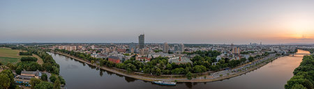 Drone panorama over Main river and Offenbach harbor with Frankfurt skyline during summer sunset