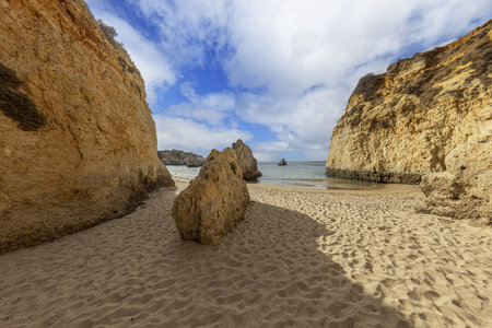 Panoramic picture between the cliffs at Praia do Prainha on the Portuguese Algarve coast during the day in summerの写真素材