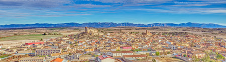 Drone panorama of the village of Almudevar in northern Spain with the Pyrenees in the background during the dayの写真素材