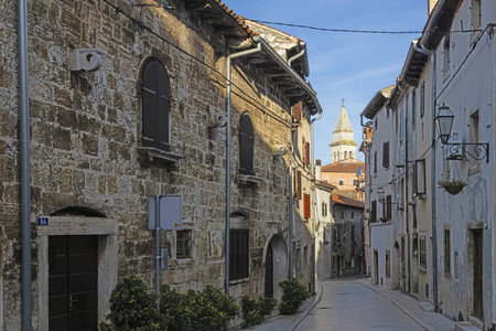Picture of a typical street scene from the historic Croatian town of Voznjan with cobbled streets and old buildings in the morning lightの写真素材