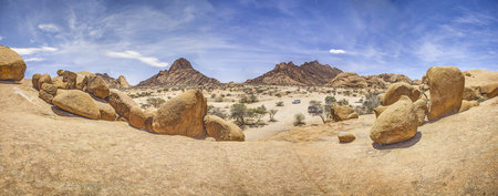Panoramic picture of the Spitzkoppe in Namibia during the day against a blue sky in summerの写真素材