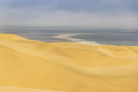 Picture of the dunes of Sandwich Harbor in Namibia on the Atlantic coast during the day in summerの写真素材