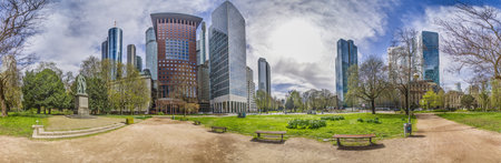 Panoramic picture of the Frankfurt skyline in front of blue sky with light clouds during the day
