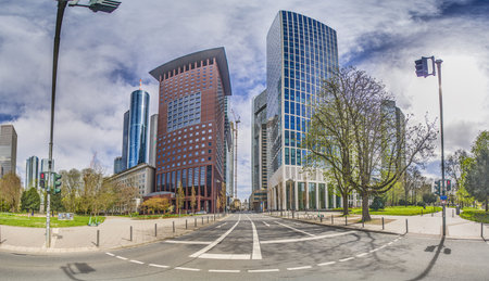 Panoramic picture of the Frankfurt skyline in front of blue sky with light clouds during the day