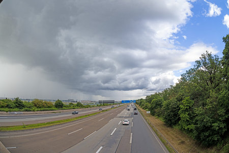 Picture of an approaching thunderstorm over Frankfurt Airport with highway during the day