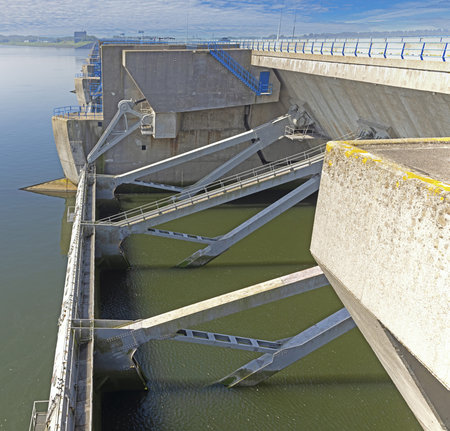 Image over the Haringvlietdam flood barrier near the Dutch town of Ouddorp against a cloudy morning skyの写真素材