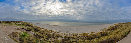 A panoramic view over the beach and dunes of the Danish coastal resort during the day