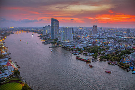 Panoramic picture of the Bankok skyline and the Chao Phyara River in the summer sunset