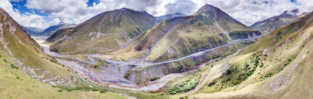 Drone view of the Pass in Georgia, showing winding roads and mountainous terrain during daytimeの写真素材