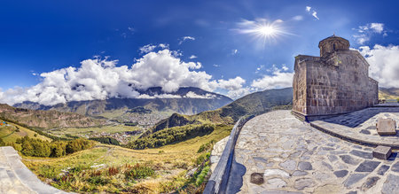 Gergeti Trinity Church near Stepantsminda, Georgia, with stunning views of the Caucasus mountains...