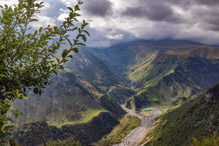 Scenic view of the Cross Pass in Georgia, showing lush green mountains and a winding valley during...