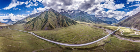 Drone view of the pass in Georgia, showing winding roads and mountainous terrain during daytimeの写真素材
