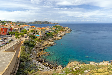 View from the fortress of Calvi in Corsica overlooking the coastline and the sea with mountains in...