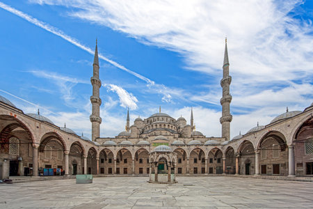 Sultan Ahmed Mosque courtyard with open space and historic Ottoman architecture during daytimeの写真素材