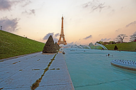 Eiffel Tower in Paris glowing in the evening sunlight with fountains in summerの写真素材