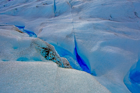 Deep crevasse on Gray Glacier in Patagonia showcasing vibrant blue ice during daytime