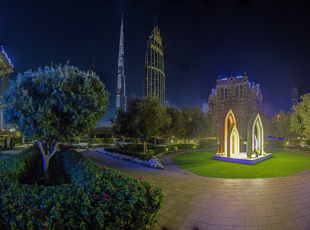 Illuminated park with famous Dubai skyline view at night in summerの写真素材
