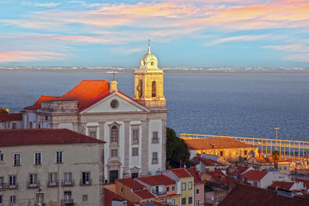 Church of Saint Stephen in Lisbon Alfama district at sunset with river view