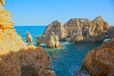 Rock formations in clear blue water at Ponta da Piedade Lagos Algarveの写真素材